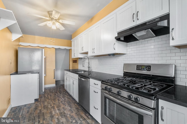 kitchen featuring under cabinet range hood, a sink, appliances with stainless steel finishes, white cabinets, and decorative backsplash