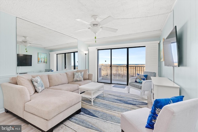 living room with ceiling fan and wood finished floors