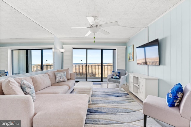 living room with ceiling fan and wood finished floors