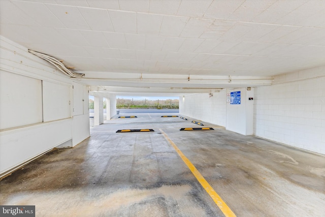 parking garage featuring concrete block wall