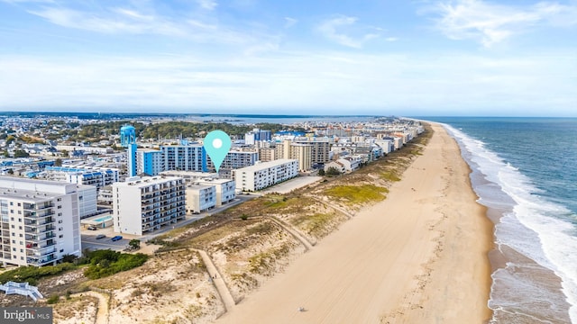 birds eye view of property with a view of city, a beach view, and a water view