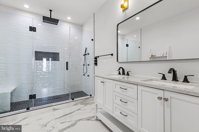 bathroom featuring double vanity, a stall shower, marble finish floor, and a sink