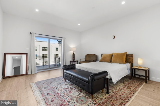 bedroom featuring light wood finished floors, recessed lighting, baseboards, and access to outside