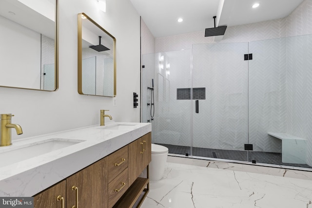 bathroom featuring a stall shower, marble finish floor, and a sink