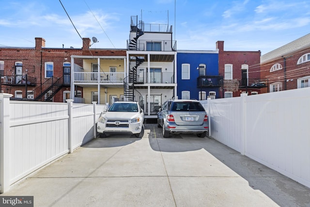 view of vehicle parking with fence