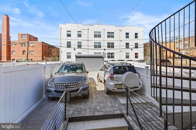 view of parking with fence