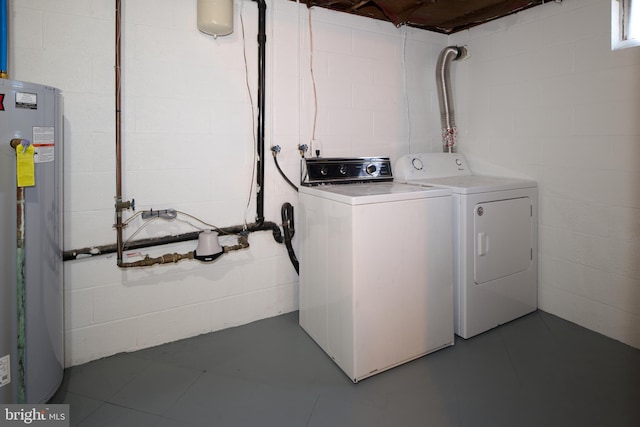 washroom featuring washer and dryer, laundry area, and water heater