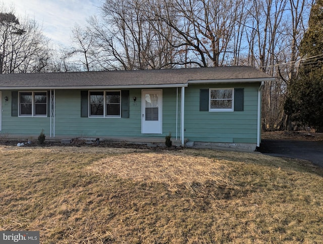 ranch-style home with a front lawn