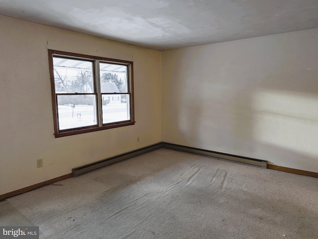 carpeted empty room featuring baseboards