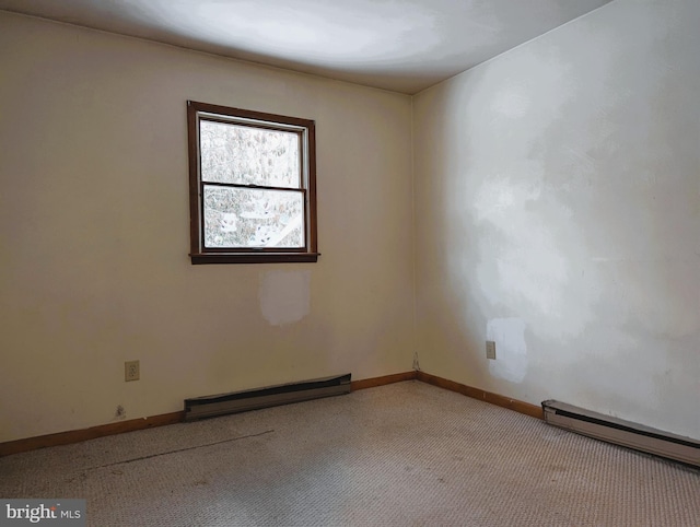 carpeted spare room featuring a baseboard radiator and baseboards