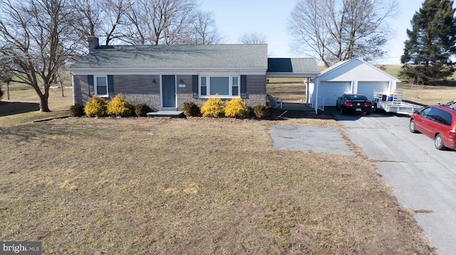 ranch-style house with a detached garage, an outbuilding, a chimney, and a front yard