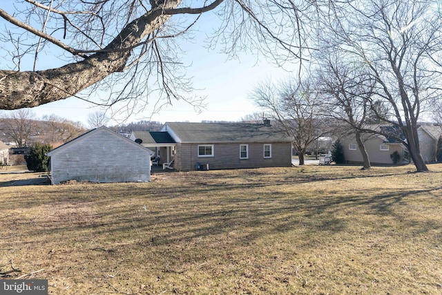 rear view of property with a yard