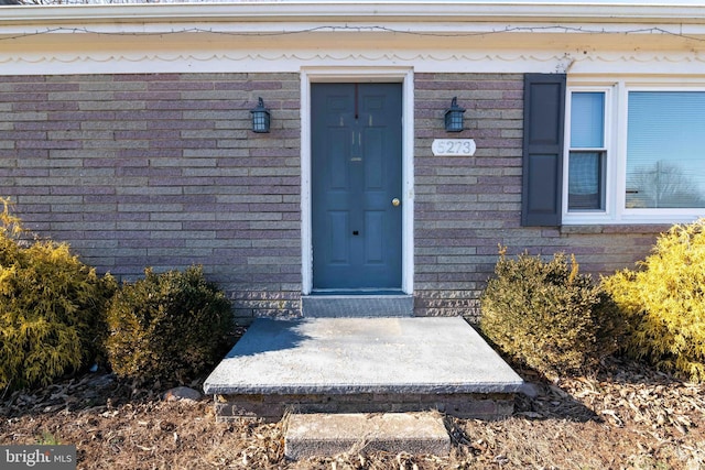 entrance to property with brick siding