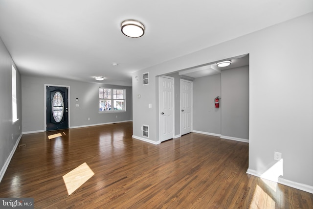 entrance foyer with baseboards, visible vents, and wood finished floors