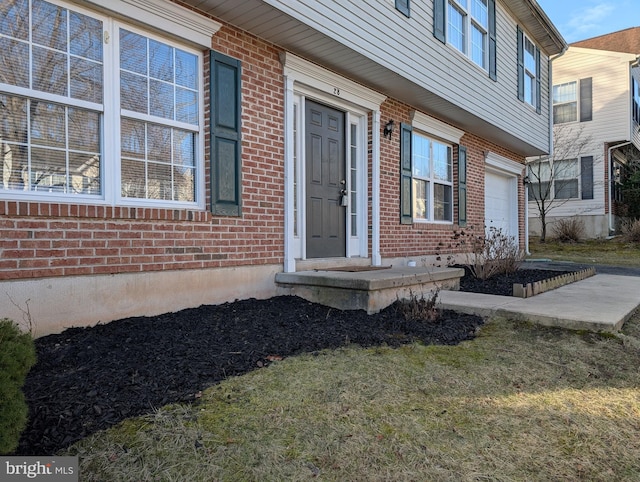 view of exterior entry with brick siding