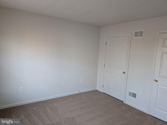 unfurnished bedroom featuring visible vents, baseboards, and carpet