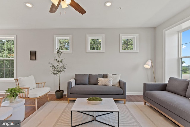 living room featuring ceiling fan, baseboards, wood finished floors, and recessed lighting