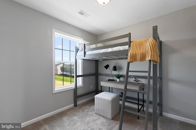 carpeted bedroom featuring visible vents and baseboards