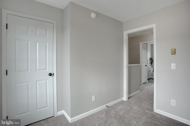 interior space with carpet floors and baseboards