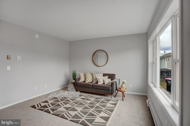 carpeted living room with a baseboard radiator and baseboards