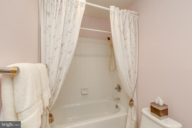 bathroom featuring toilet and shower / bath combo