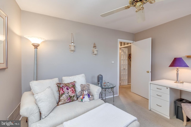 bedroom with light colored carpet, ceiling fan, and baseboards