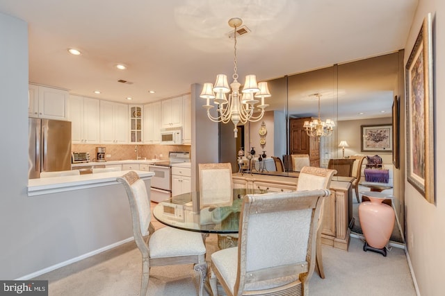 dining space with recessed lighting, visible vents, a chandelier, and light colored carpet