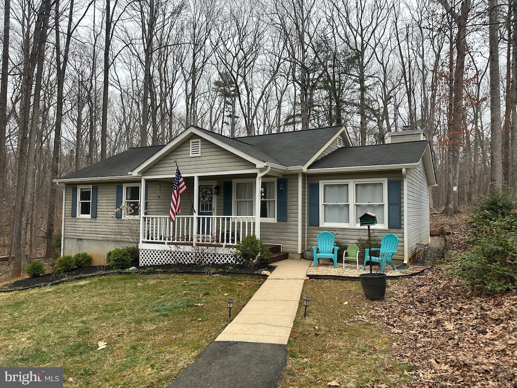 view of front of house with crawl space, covered porch, and a front lawn