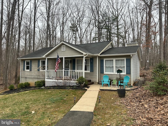 view of front of house with crawl space, covered porch, and a front lawn