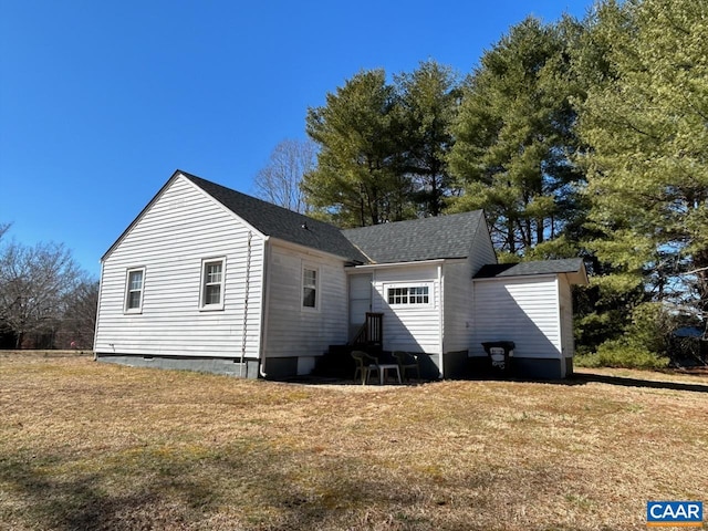 back of property featuring a lawn