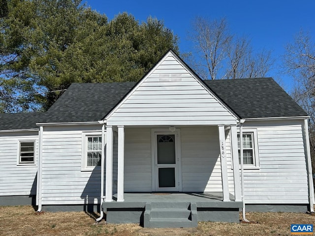 view of front of house with covered porch and roof with shingles