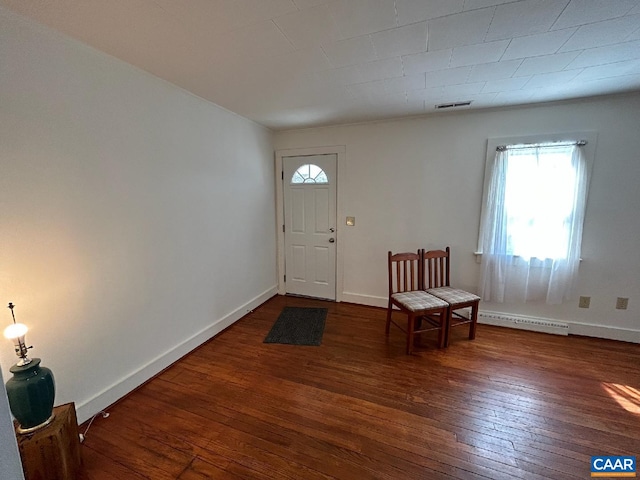 entryway with hardwood / wood-style floors, a baseboard radiator, visible vents, and baseboards