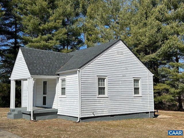 view of home's exterior with a shingled roof