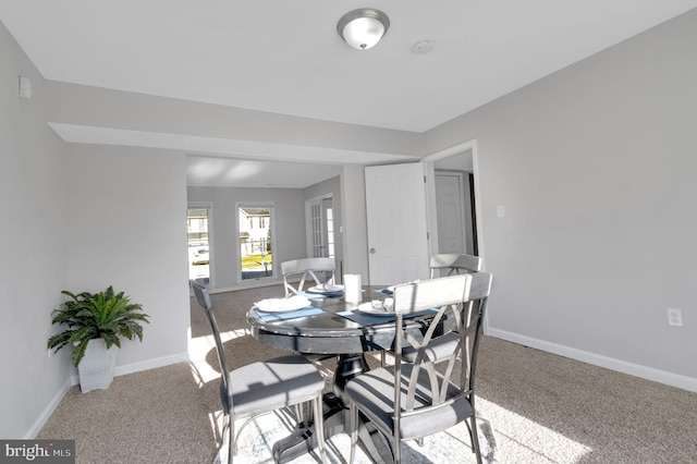 dining room with carpet floors and baseboards