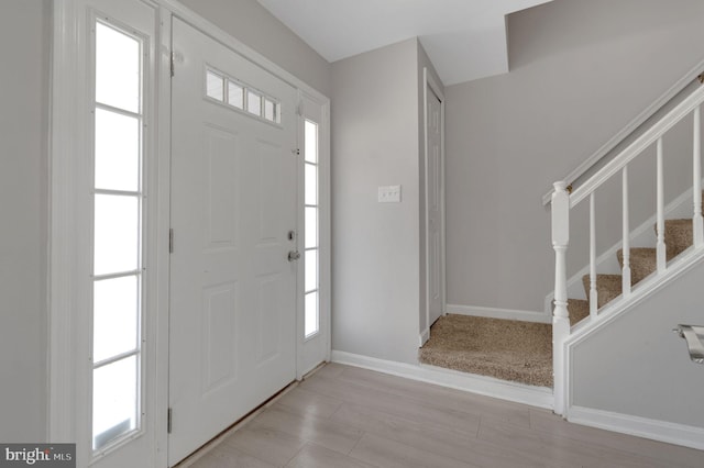 entryway with stairs and baseboards