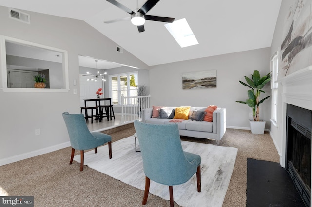 living area featuring vaulted ceiling with skylight, carpet floors, a fireplace, visible vents, and baseboards