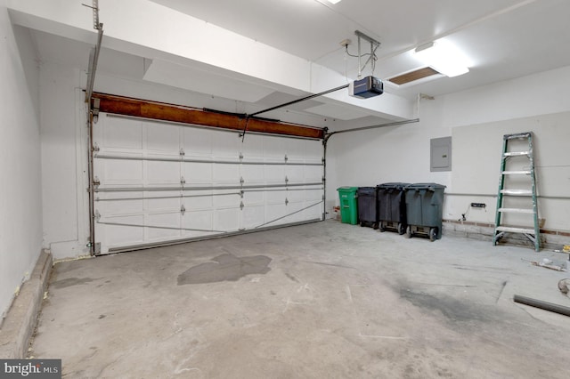 garage featuring electric panel and a garage door opener