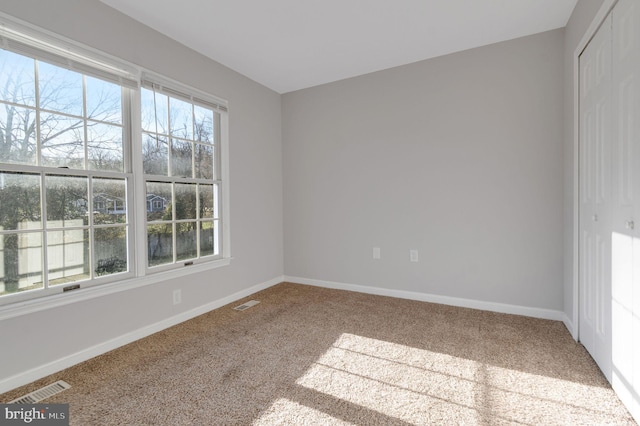 interior space with multiple windows, a closet, and visible vents