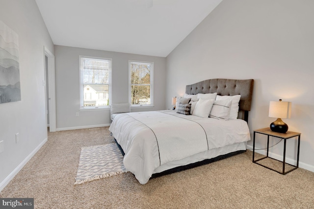 carpeted bedroom featuring lofted ceiling and baseboards