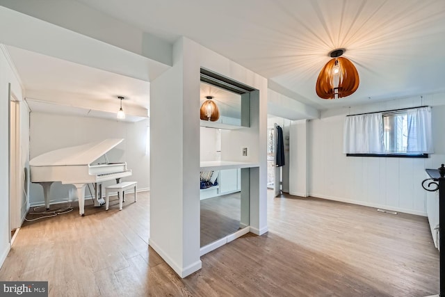 interior space featuring baseboards and wood finished floors