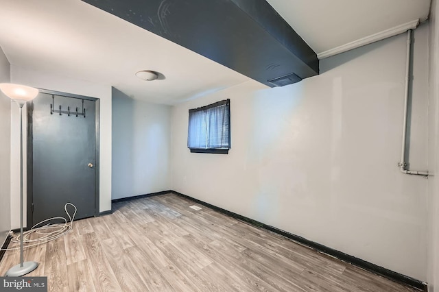 interior space with light wood finished floors and baseboards