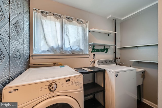 clothes washing area featuring laundry area and washer and clothes dryer