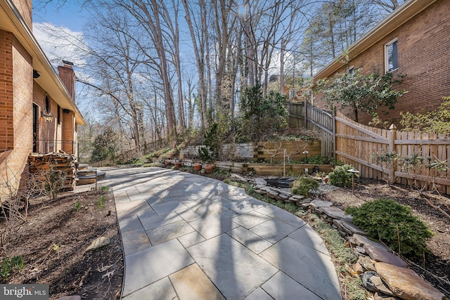 view of patio featuring fence