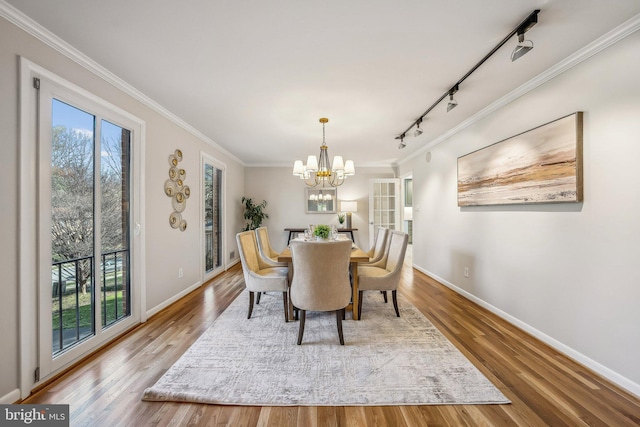 dining space featuring plenty of natural light, wood finished floors, and ornamental molding