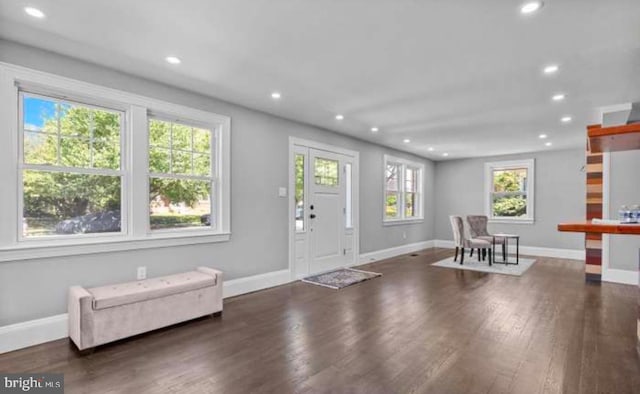 foyer featuring baseboards, wood finished floors, and recessed lighting