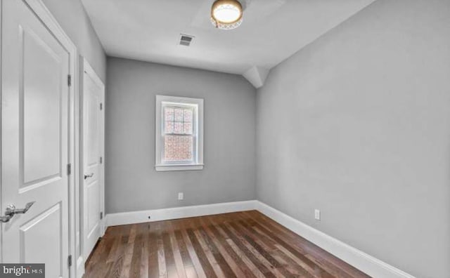 unfurnished bedroom with dark wood finished floors, visible vents, and baseboards