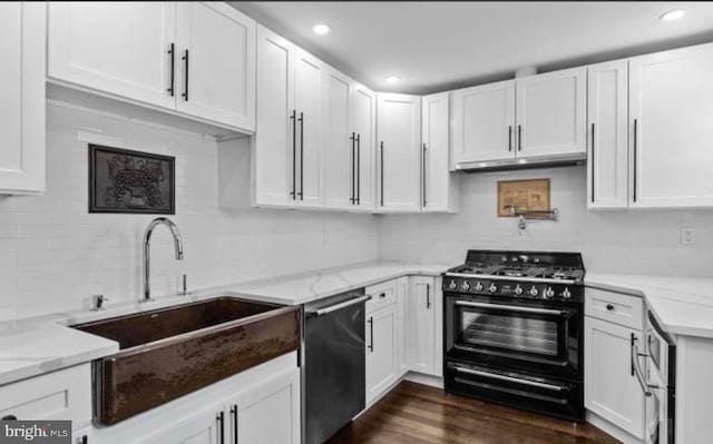 kitchen with dishwasher, gas range oven, a sink, and white cabinets