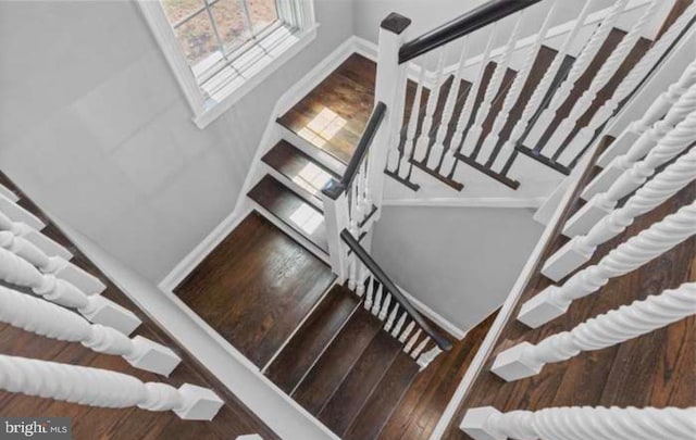 stairs featuring baseboards and wood finished floors