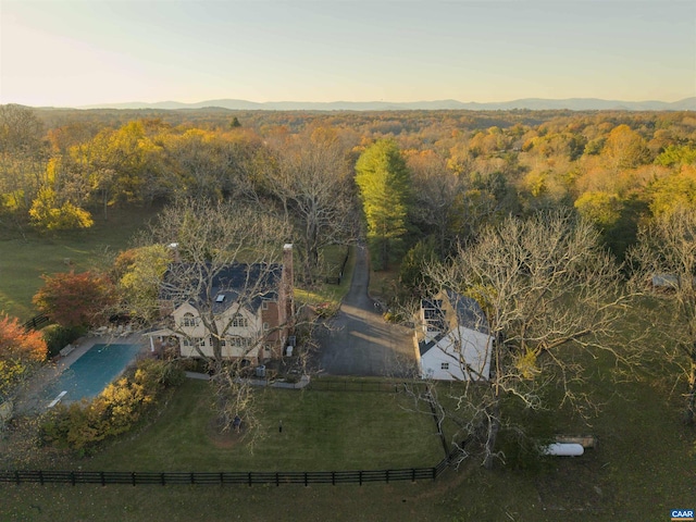 drone / aerial view featuring a mountain view and a wooded view