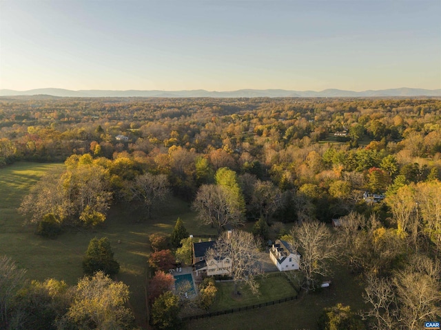 drone / aerial view featuring a mountain view and a wooded view